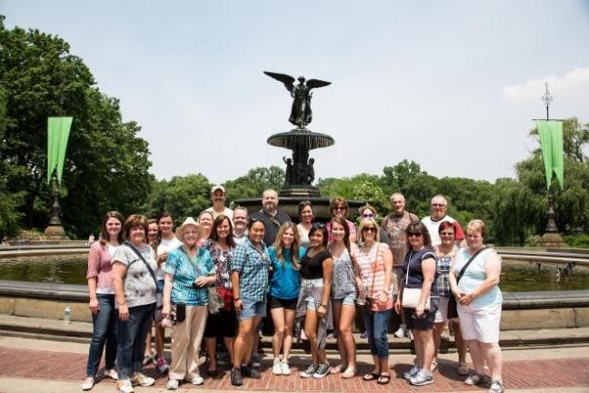 a group of people standing in front of a crowd posing for the camera