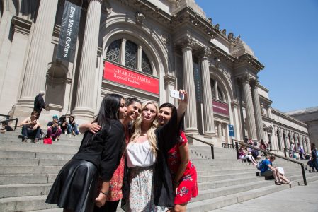 a group of people walking in front of a building