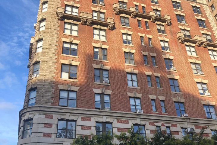 a large brick building with a tall tower