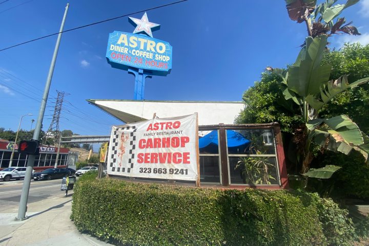 a sign in front of a statue