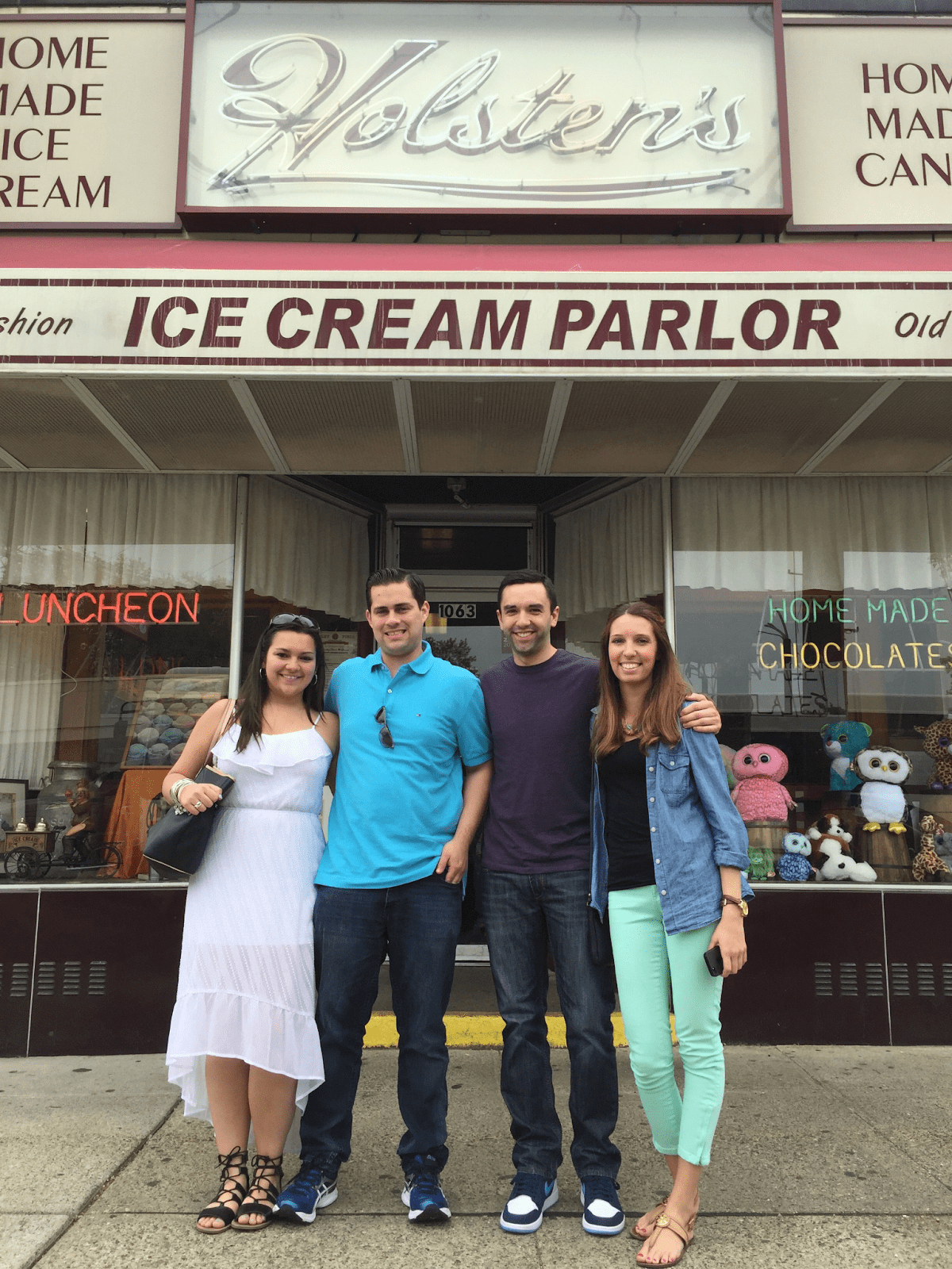 a group of people standing in front of a store