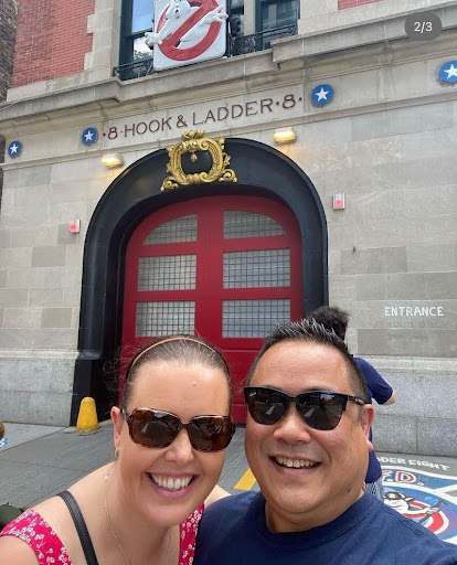 a man and a woman standing in front of a building